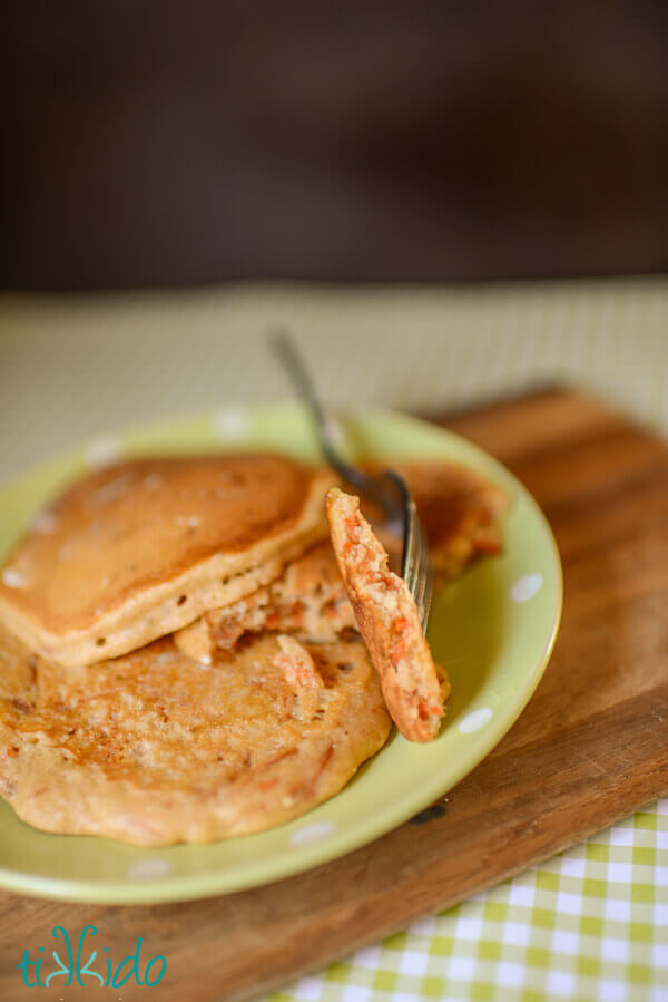 Carrot cake pancakes on a light green and white polka dot plate.