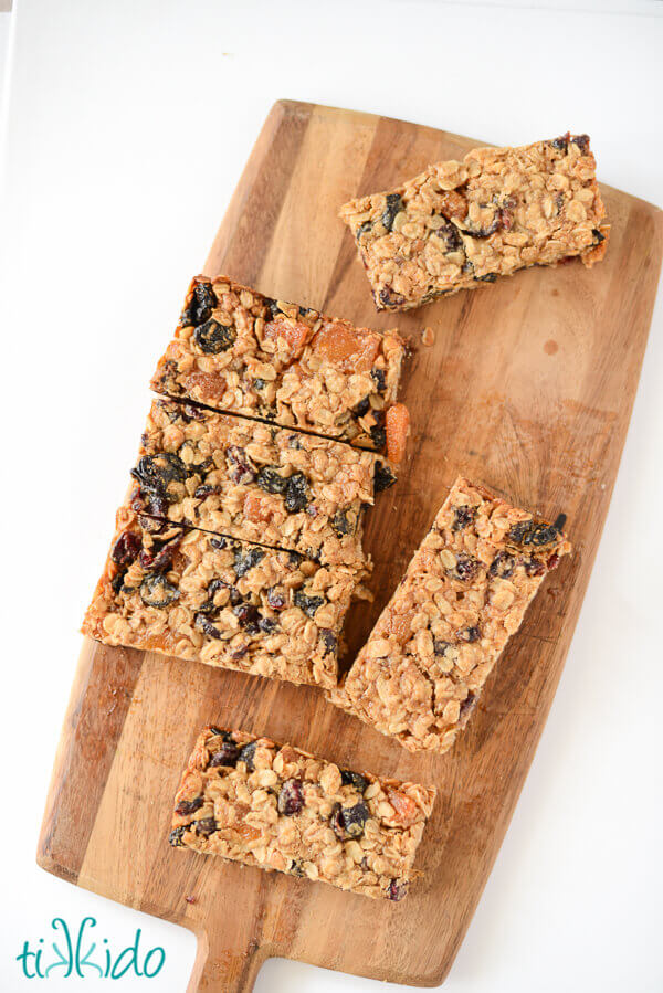 Homemade soft granola bars on a wooden cutting board.