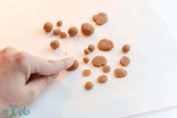 Gingerbread cobblestones being made out of gingerbread dough.