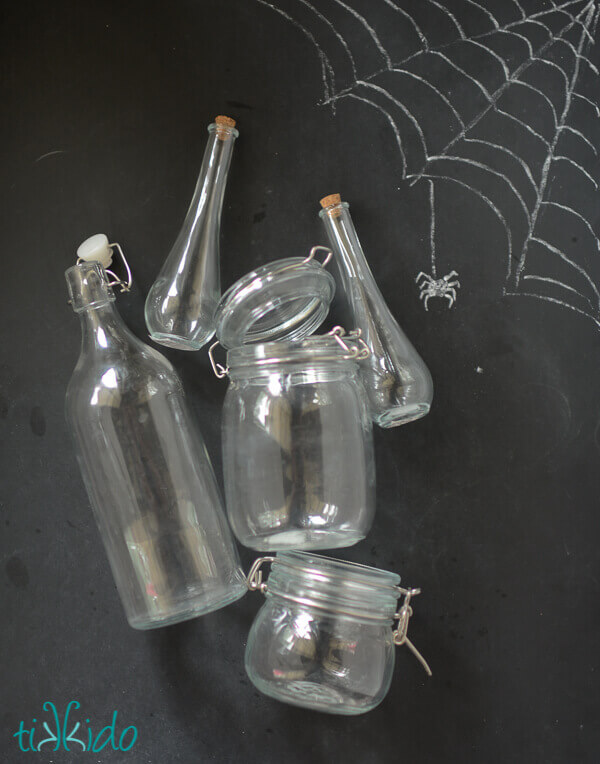 Bottles for making Halloween potion bottles on a black chalkboard background.
