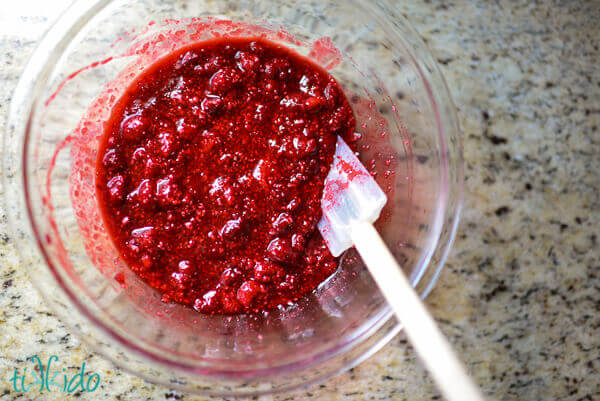 Cherry pie filling recipe ingredients mixed together in a clear bowl.