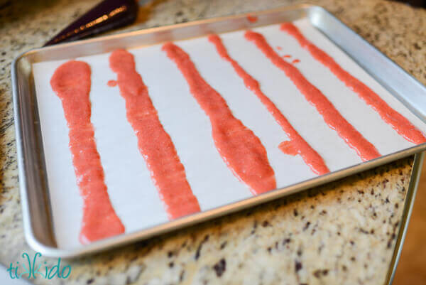 Fruit puree spread in baking pan ready to dehydrate into homemade fruit roll ups.