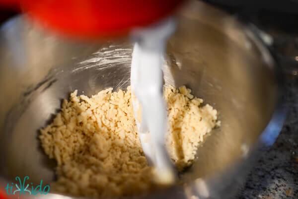Homemade Cheese Cracker ingredients being mixed in a Kitchenaid mixer to form the dough.