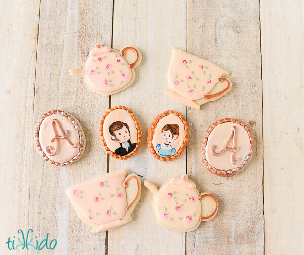Jane Austen Tea Party sugar cookies on a whitewashed wood background.