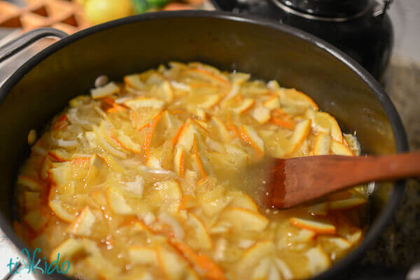 Large pot full of homemade marmalade being cooked on the stove.