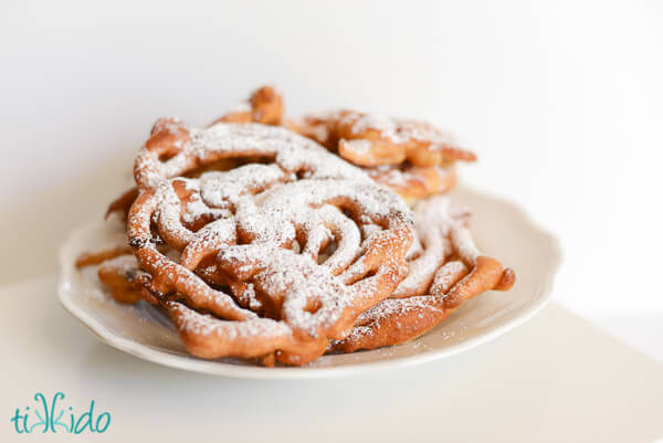 Homemade funnel cakes dusted with powdered sugar.