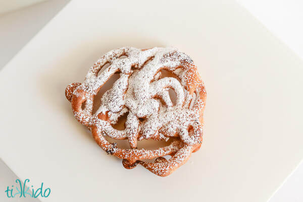 Homemade funnel cakes dusted with powdered sugar.