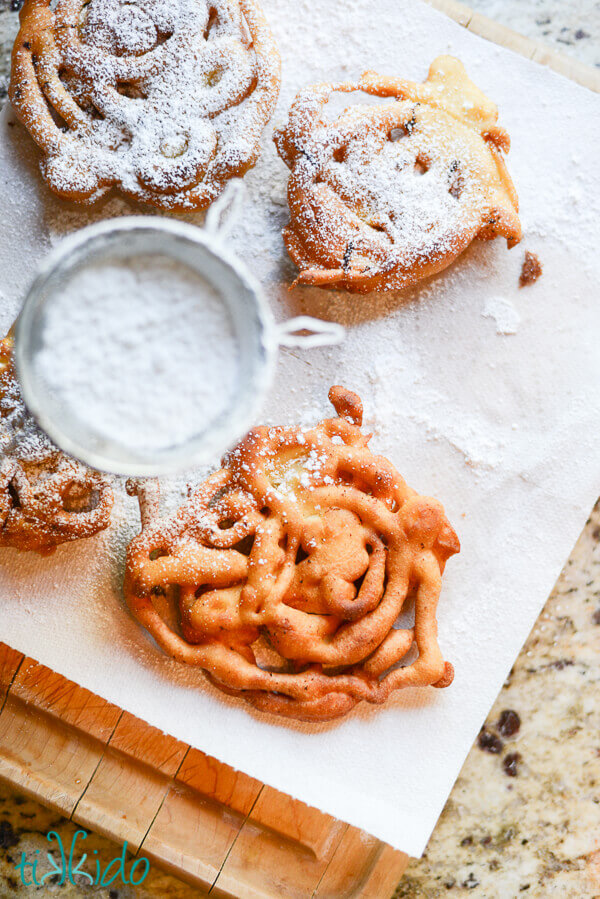 Homemade funnel cakes dusted with powdered sugar.