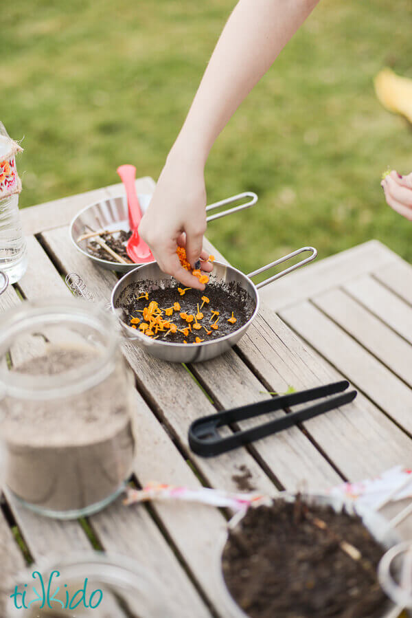 Little girl making mud pies