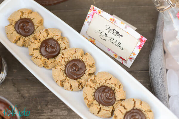 Peanut Butter Nutella Thumbprint Cookies on a white serving tray.