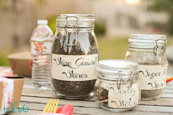 Glass jars filled with dirt and leaves for the Mud Pie birthday party.