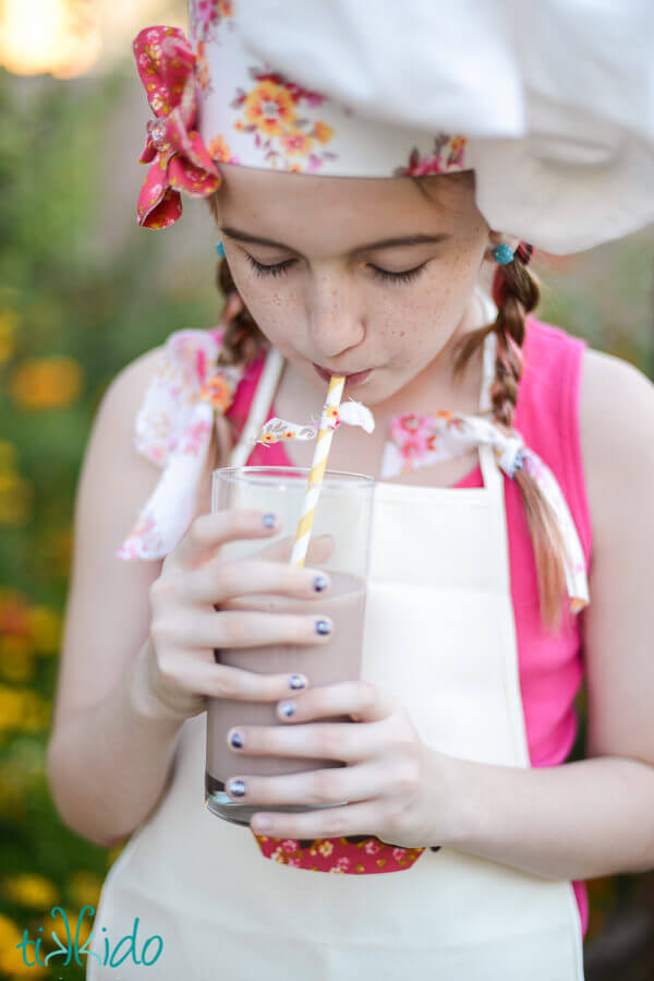 Little girl drinking chocolate milk.