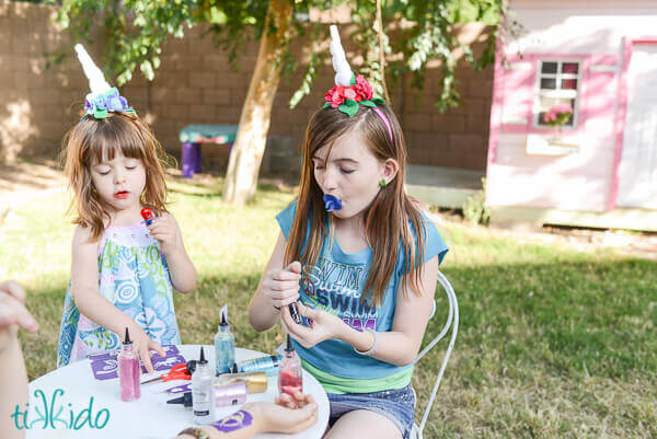 Two girls wearing unicorn horns at the My Little Pony birthday