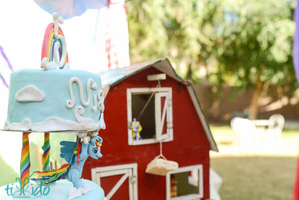 My Little Pony cake in foreground, antique dollhouse barn in background.