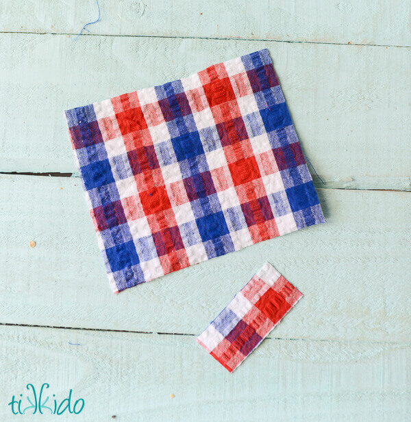 Rectangle of red, white, and blue seersucker plaid fabric for a no sew hair bow.