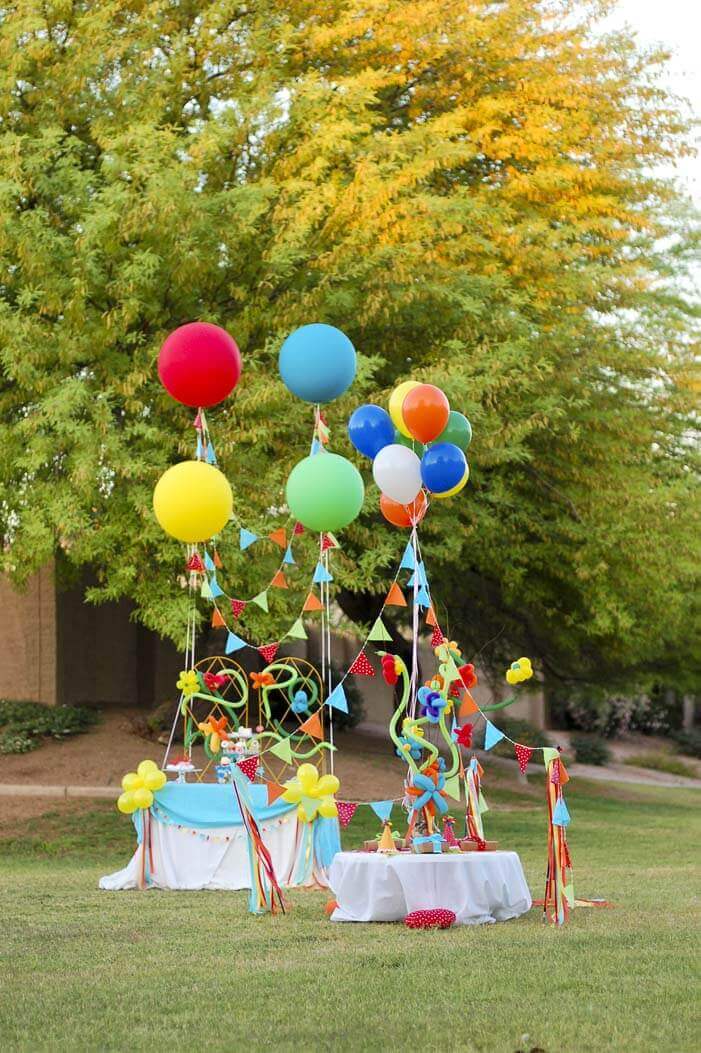 Setup for a balloon themed birthday party in a park.