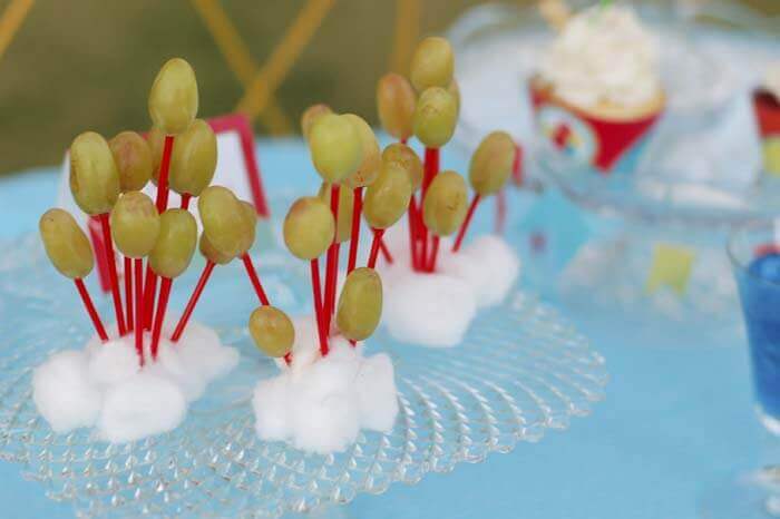 Green grapes displayed to look like bunches of balloons at the balloon birthday party.