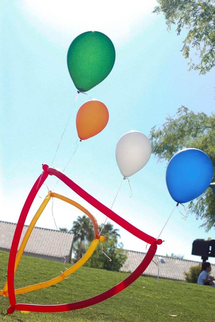 Obstacle course made from balloons in a park at a balloon themed birthday party.