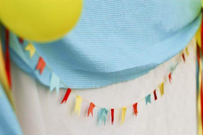 Miniature ribbon bunting decorating a dessert table.