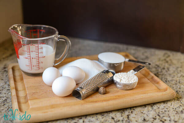 Rhubarb custard pie ingredients on a wooden cutting board.