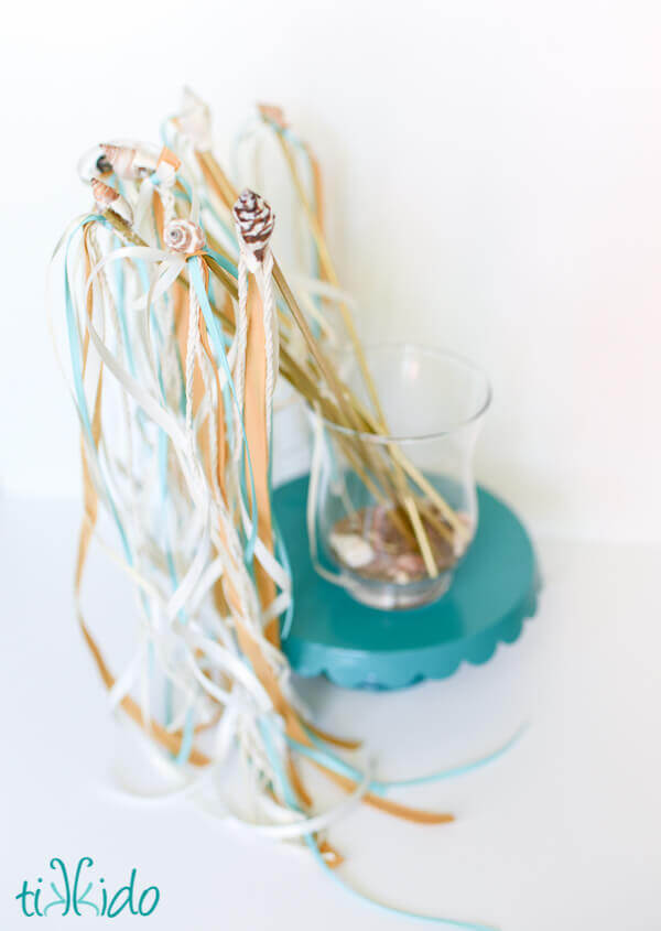 Glass container holding Wedding Ribbon Wands on a white background.