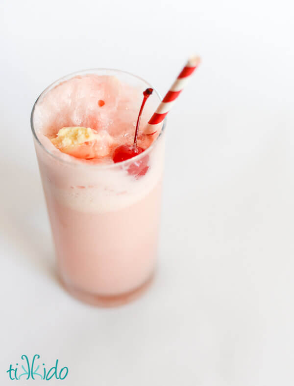 Top down view of a Shirley Temple Ice Cream Float on a white background.