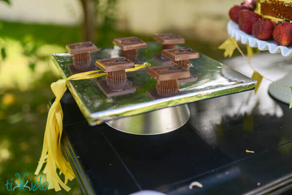 chocolate graduation caps displayed at a graduation party.