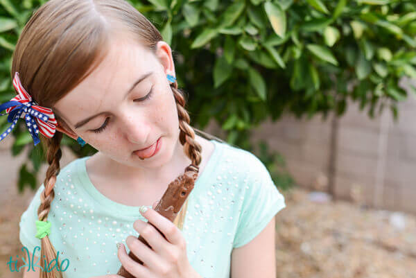 Little girl enjoying a vegan fudgesicle.