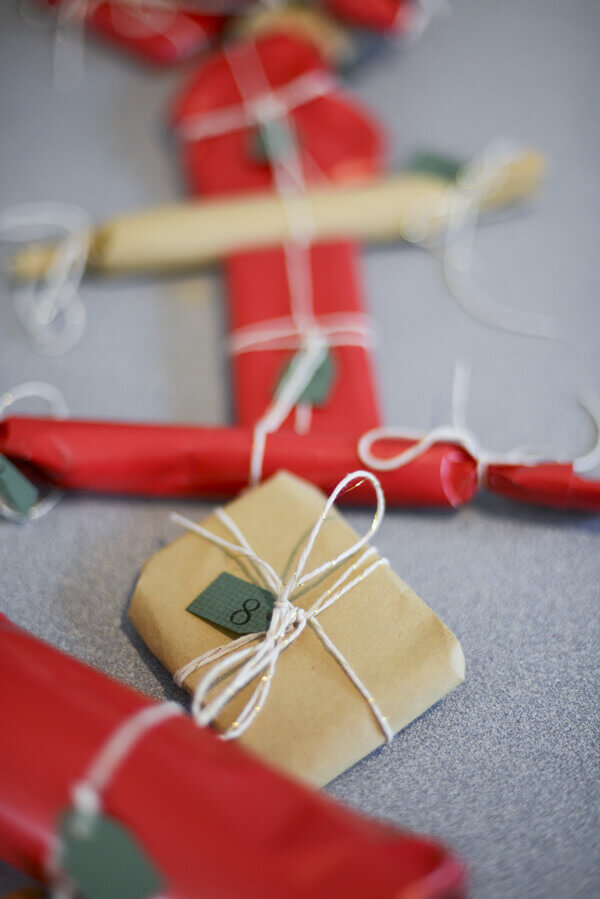 Advent calendar made from a garland of small, individually wrapped presents.