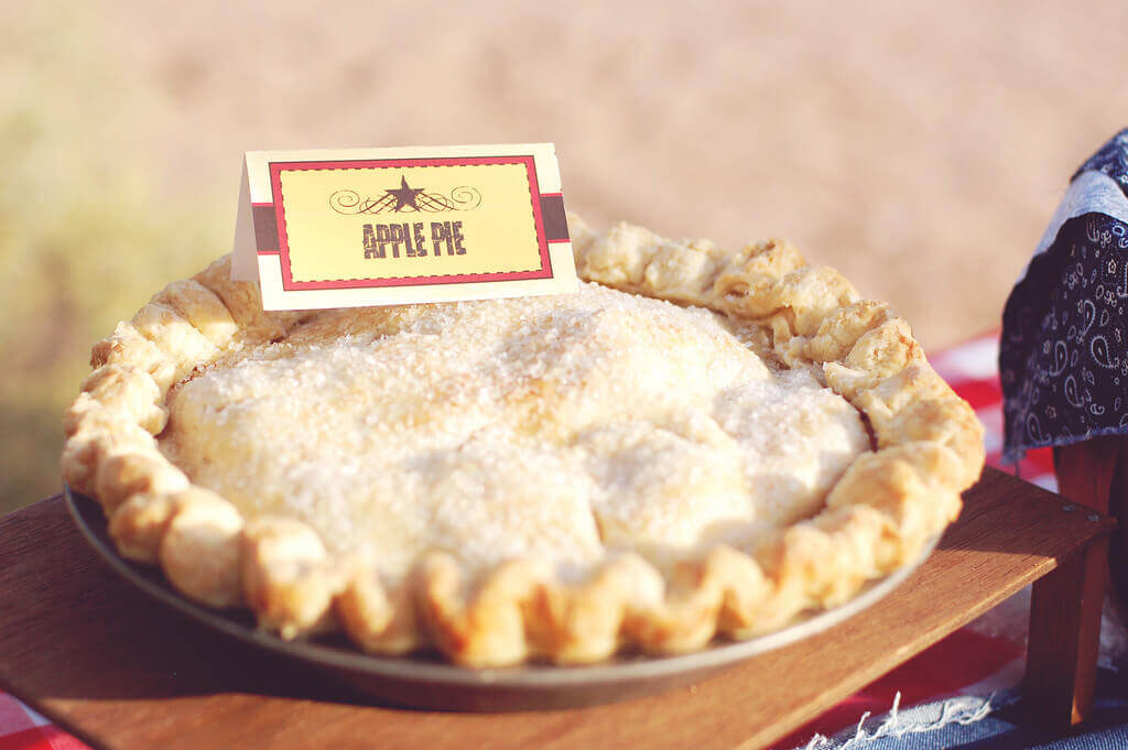 Homemade apple pie on a picnic table.