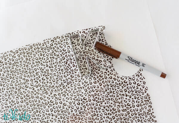 Leopard print chocolate transfers being cut into K shapes.