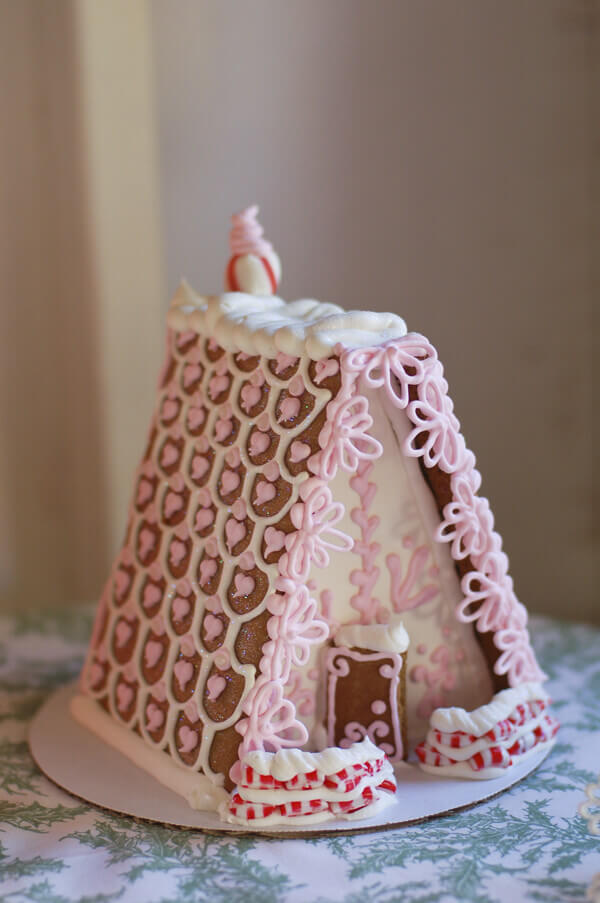 Pink and white A Frame gingerbread house.