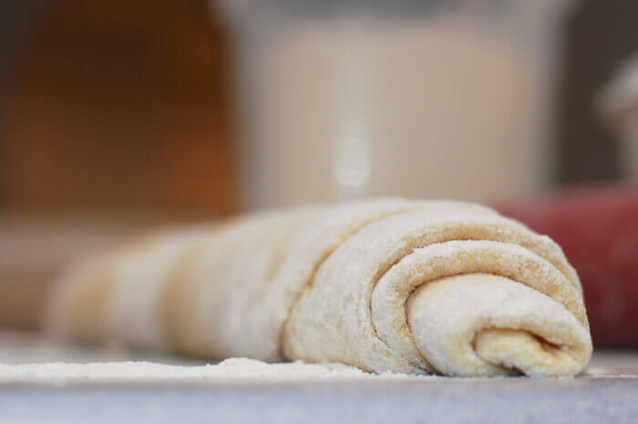 Cinnamon roll dough rolled into a long log