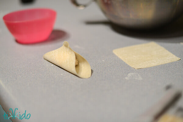 Preparing Crab Rangoon for cooking.