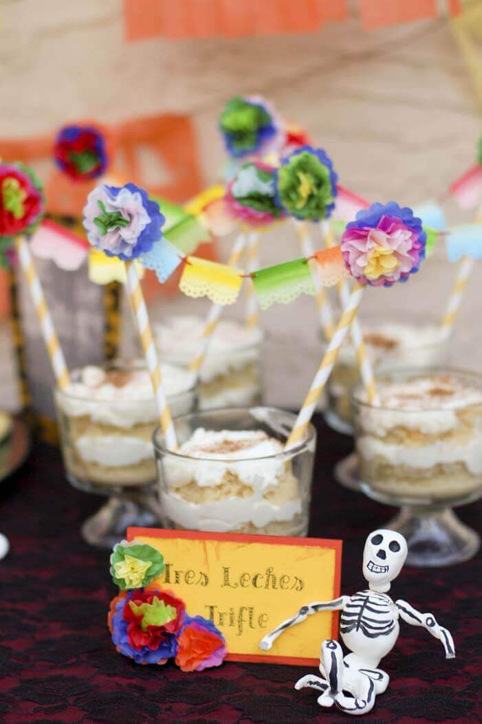 Miniature Mexican papel picado bunting decorating small trifle dishes with tres leches cake.