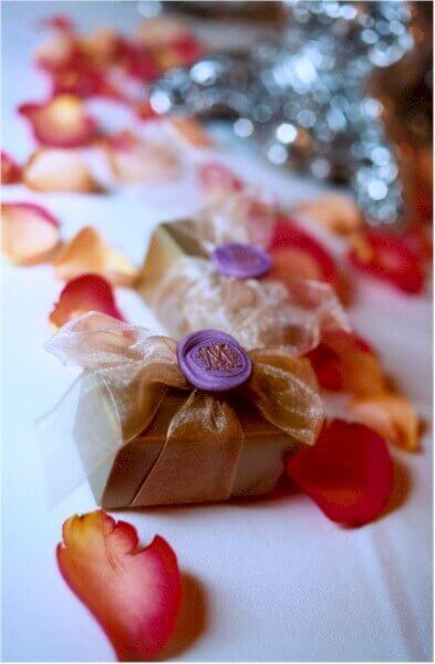 Faux wax seals topping a small gold favor box.