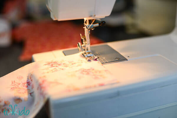 Strips of fabric ribbon being sewn together to create longer fabric ribbon.