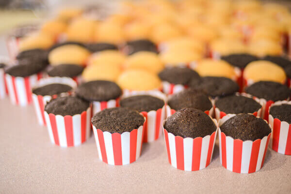 Chocolate and vanilla cupcakes baked in red and white striped paper baking cups to make popcorn cupcakes