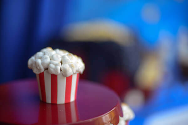 Cupcake topped with toasted marshmallows to make popcorn cupcakes.