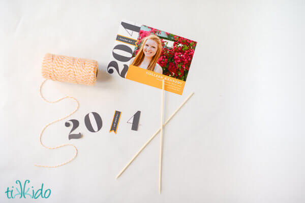 DIY Graduation Cake Topper being cut out of a graduation announcement.