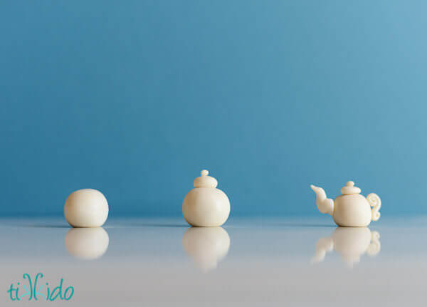 Steps showing the progression of sculpting a tiny gum paste tea pot for a tea party cupcake