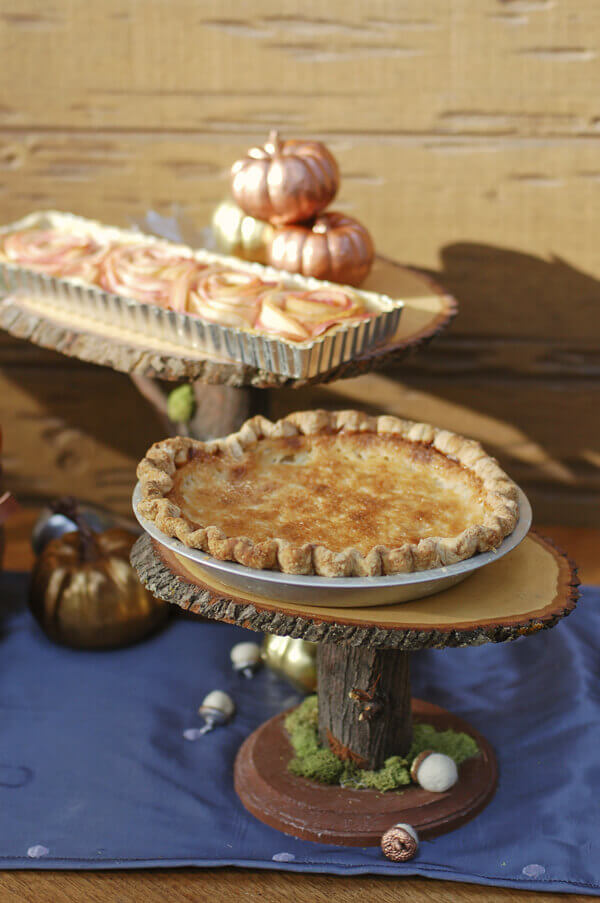 Old Fashioned hand pie (an eggless vanilla custard pie) on a wooden cake stand.