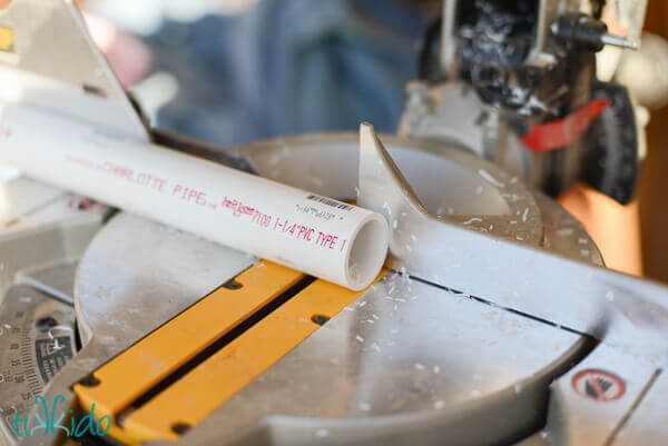 PVC pipe being cut into rings to make Lord of the Rings napkin rings.