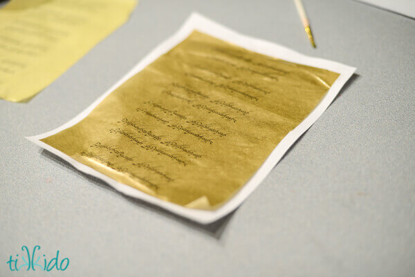 Gold tissue paper printed with the engraved words on the One Ring from Lord of the Rings.