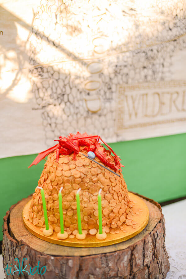 Lord of the Rings birthday party cake decorated like Smaug on top of a horde of golden coins.