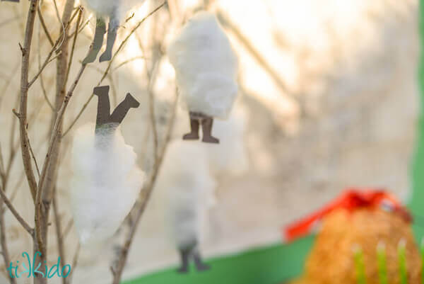 Cotton candy that looks like dwarves wrapped in spider silk, hanging from tree branches on the Lord of the Rings birthday party dessert table.