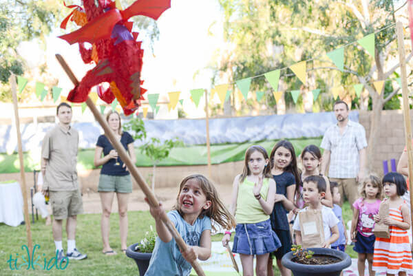 Kids hitting the Smaug piñata at the Hobbit birthday party.