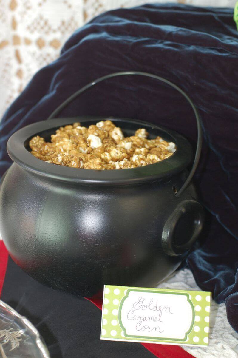 Caramel corn in a black plastic cauldron for St. Patrick's day.