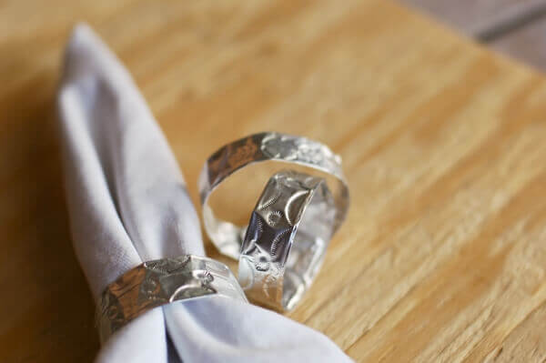 DIY napkin rings made to look like traditional Mexican punched tin work.
