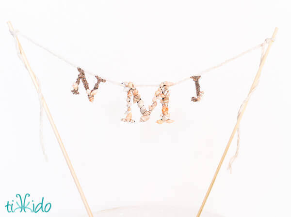 Nautical Monogram Cake Topper made with tiny shells and sand.